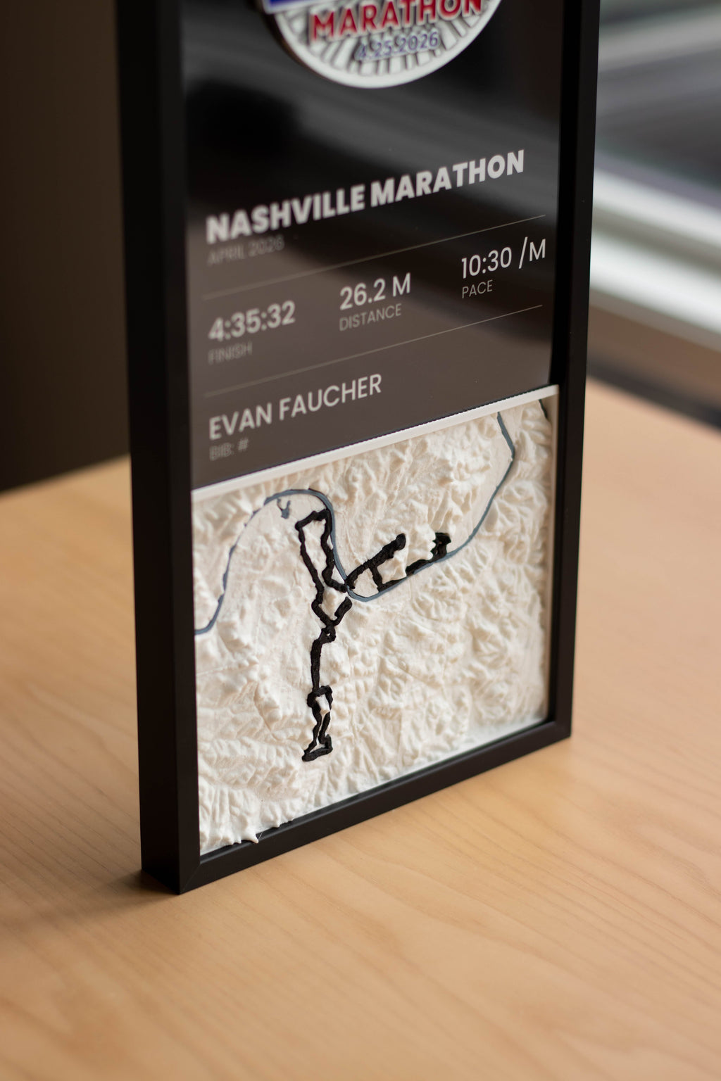Example race panel with finish time, distance and pace above a 3D relief map of the course